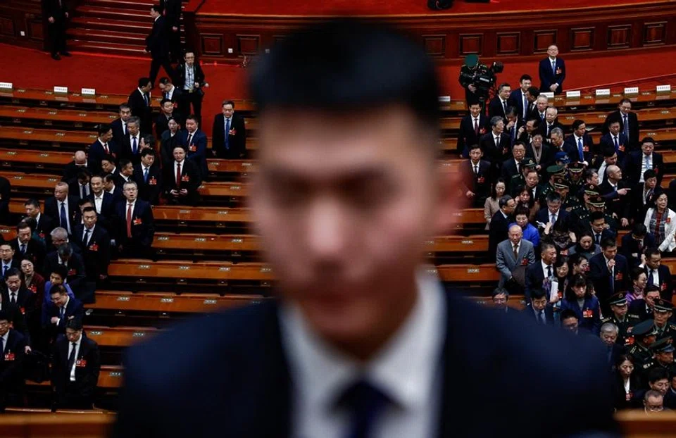 A security personnel stands guard as delegates leave following the second plenary session of the National People's Congress (NPC) at the Great Hall of the People in Beijing, China, on 9 March 2026. (Tingshu Wang/Reuters)