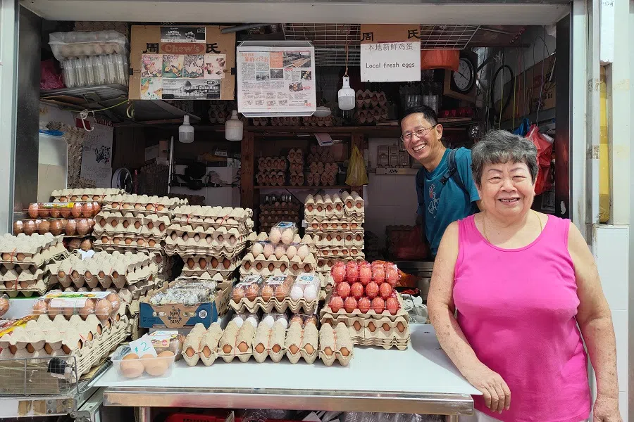 Liu is happy to chat with the egg seller in the market. (Kenny Chan/SPH Media)