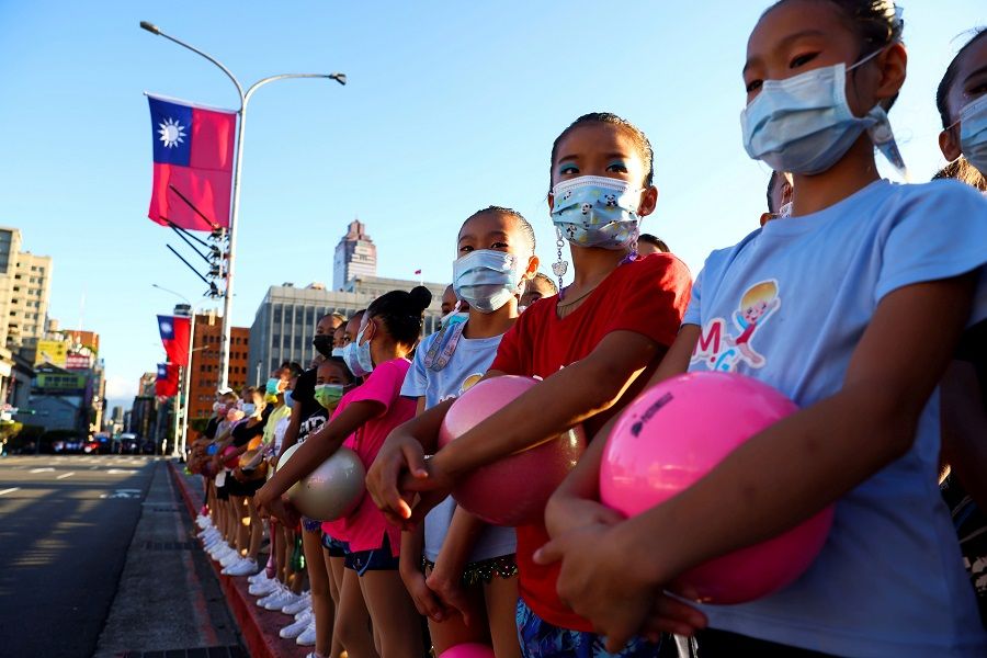 Girls at a rehearsal ahead of the Double Tenth Day celebration in front of presidential office in Taipei, Taiwan, 10 October 2021. (Ann Wang/Reuters)