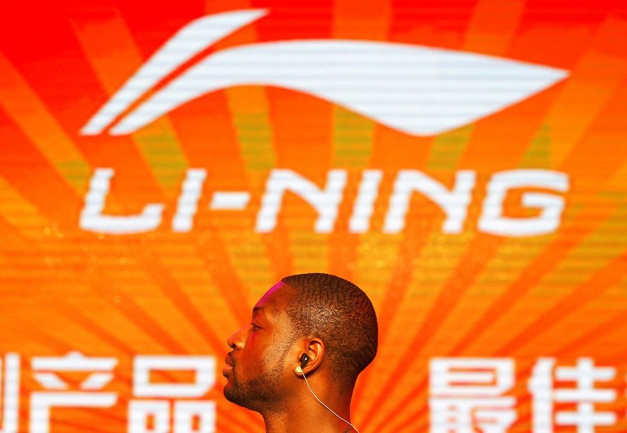 NBA Miami Heat's Dwyane Wade stands in front of a company logo of Li-Ning during a promotional event for Li-Ning's Way of Wade sneakers, in Beijing, 3 July 2013. (Barry Huang/File Photo/Reuters)