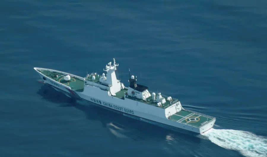 An aerial view of a China Coast Guard ship navigating near the disputed Scarborough Shoal, as Philippine Coast Guard aircraft carrying journalists patrols the area, days after two Chinese vessels collided in the area while allegedly trying to block a Philippine supply mission, in the South China Sea, on 13 August 2025. (Adrian Portugal/Reuters)
