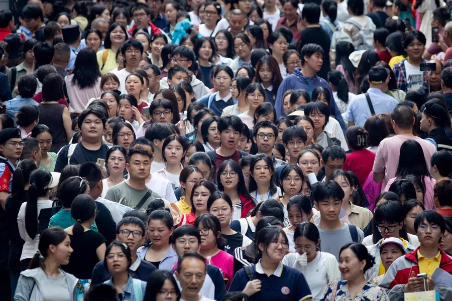 Students walk out to meet their parents after sitting China’s National College Entrance Examination, known as “gaokao”, on 7 June 2025. (AFP)