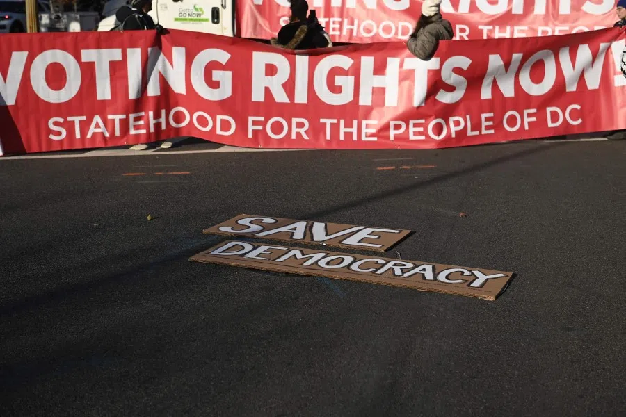 Demonstrators protest on 7 December 2021, in support of voting rights and statehood for Washington, DC. (Brendan Smialowski/AFP)