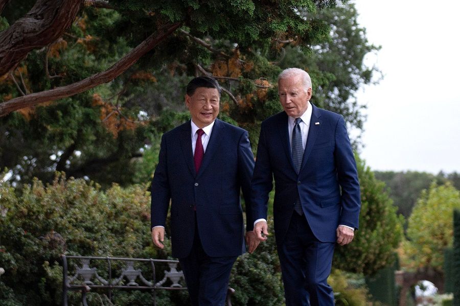 US President Joe Biden and Chinese President Xi Jinping walk together after a meeting during the Asia-Pacific Economic Cooperation (APEC) Leaders' week in Woodside, California, on 15 November 2023. (Brendan Smialowski/AFP)