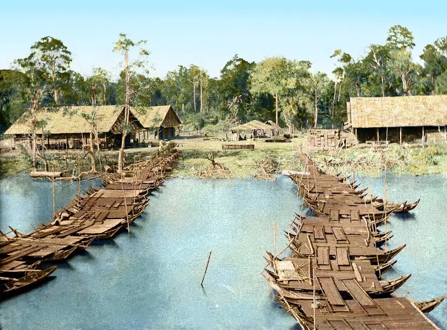 A view of the bridge to the pier and the godowns and forest on the riverbank as seen from the boat, 1900s. This is a classic scene of the Kallang River in the early days, featuring the primary rainforest setting.