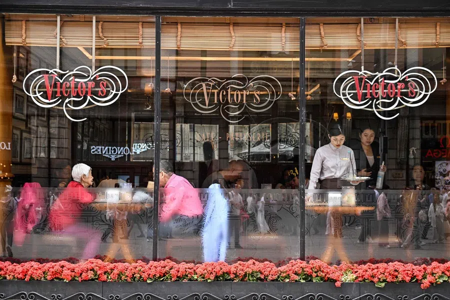 People are seen in a restaurant in the Huangpu district in Shanghai, China, on 11 April 2025.