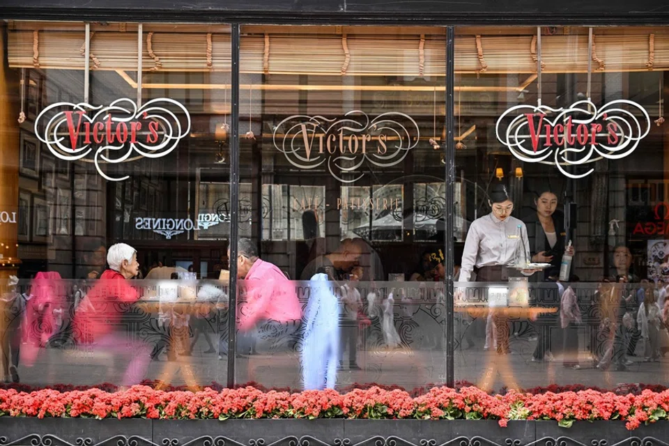 People are seen in a restaurant in the Huangpu district in Shanghai, China, on 11 April 2025. (Hector Retamal/AFP)