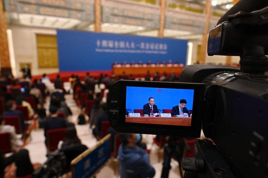 China's Premier Li Qiang is seen on the screen of a video camera as he speaks during a press conference following the closing session of the National People's Congress at the Great Hall of the People in Beijing on 13 March 2023. (Greg Baker/AFP)