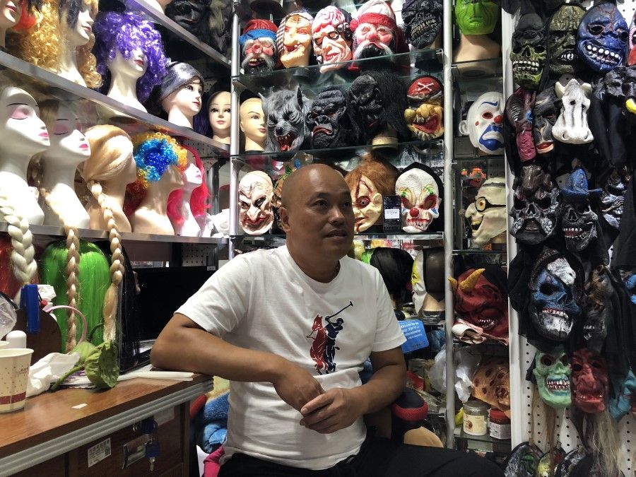 A mask and wig vendor in Yiwu.