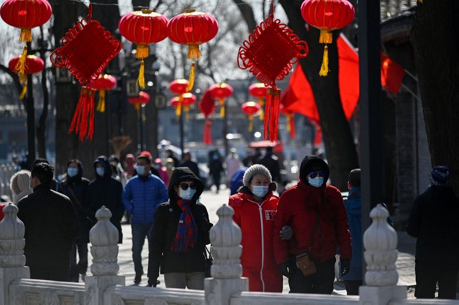 People visit a business street in Beijing, China, on 17 February 2021. (Wang Zhao/AFP)