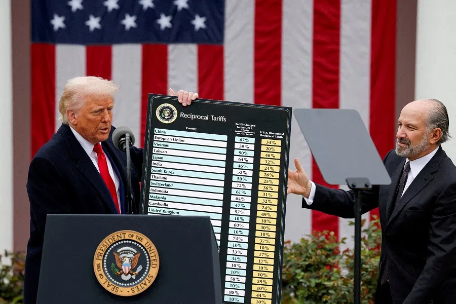 US President Donald Trump holds a chart next to US Secretary of Commerce Howard Lutnick as Trump delivers remarks on tariffs in the Rose Garden at the White House in Washington, DC, US, 2 April 2025. (Carlos Barria/Reuters)