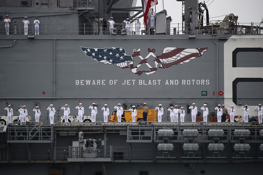Service men and women salute on the deck of the USS America (LHA-6) during a ceremony marking the 73rd Anniversary of Incheon Landing on 15 September 2023. (Chung Sung-Jun/AFP)
