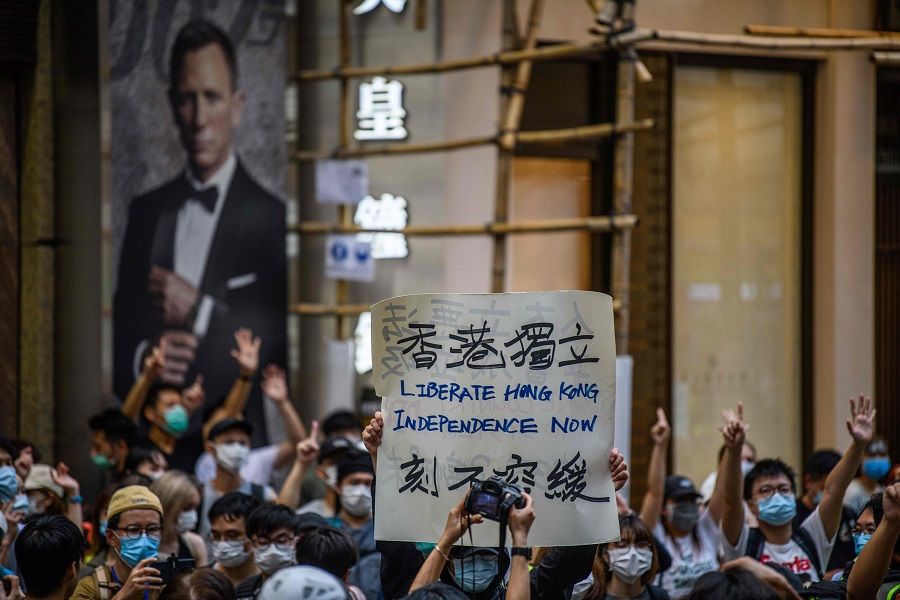 Protesters chant slogans and hold a placard during a rally against a new national security law in Hong Kong on 1 July 2020. (Anthony Wallace/AFP)