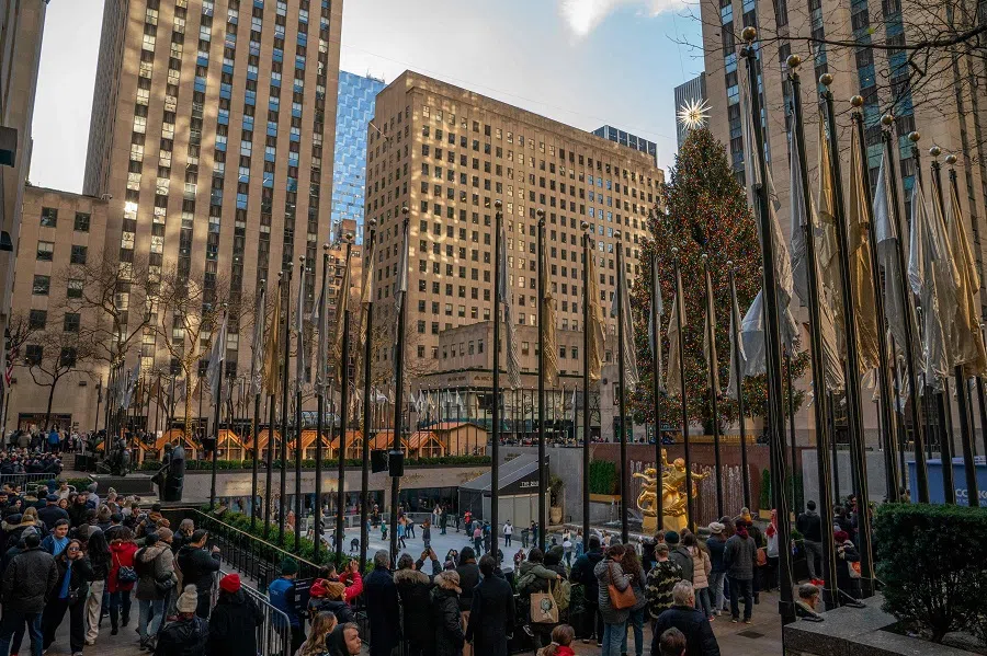 People gather near the Rockefeller Center Christmas Tree on 20 December 2023 in New York City, US. (David Dee Delgado/Getty Images/AFP)