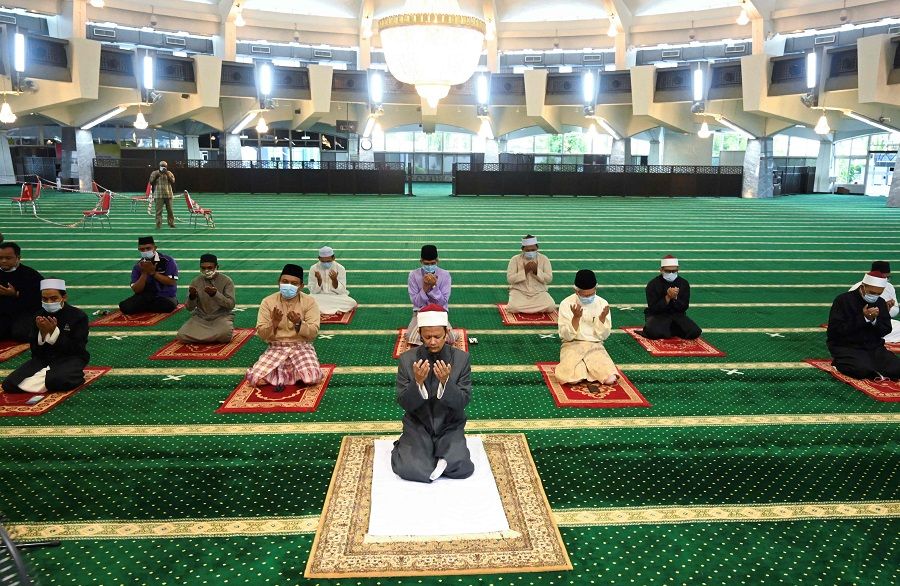 Devotees attend Friday prayers at the state mosque in Penang, ahead of the Eid al-Fitr that marks the end of the Muslim holy month of Ramadan on 22 May 2020. (Goh Chai Hin/AFP)