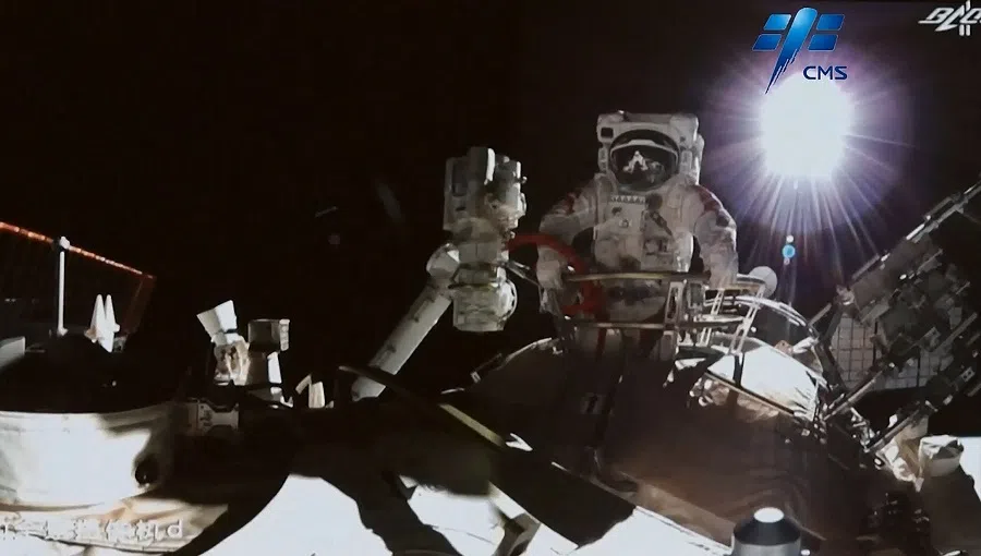 This screen grab made from video released by Chinese state broadcaster CCTV shows Chinese astronaut Zhai Zhigang stepping outside China's Tiangong space station in orbit around Earth on 7 November 2021. (Handout/CCTV/AFP)
