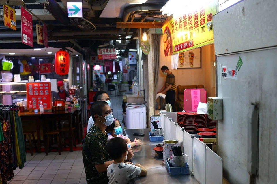 A family waits for their food to be served at a restaurant in Keelung, Taiwan, 23 May 2022. (Ann Wang/Reuters)