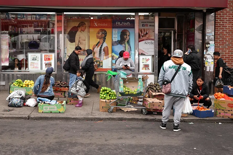 People sell fruits and vegetables in a street in the Corona Plaza area of the Queens borough of New York City, a largely migrant neighbourhood, on 20 March 2025. (Charly Triballeau/AFP)