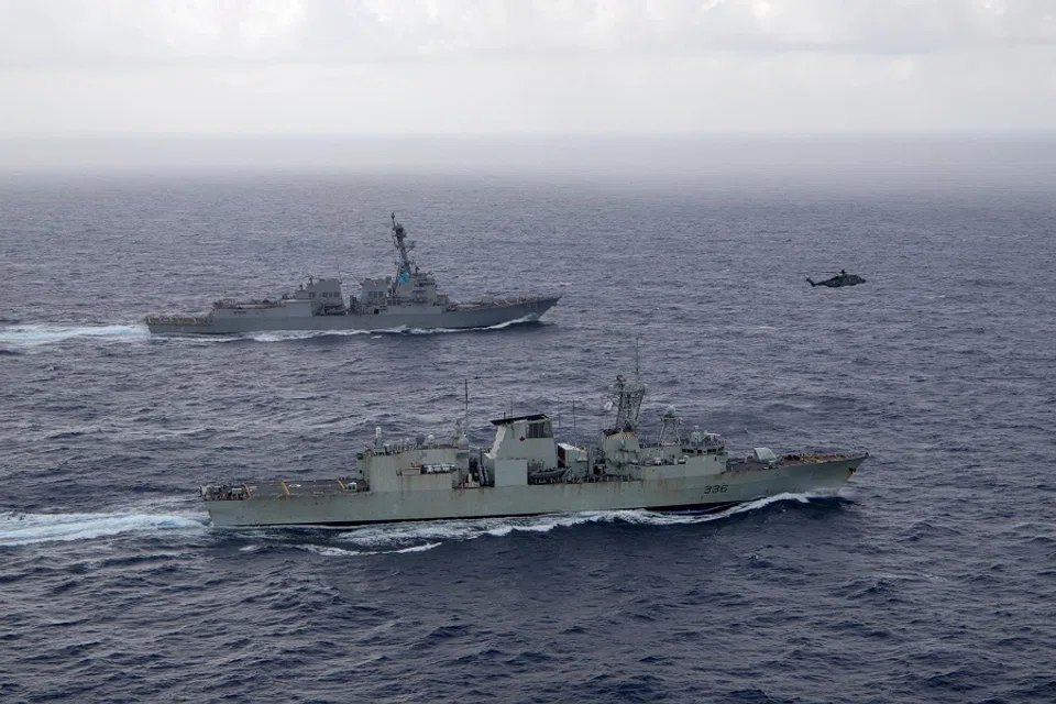 US Navy guided-missile destroyer USS Chung-Hoon sails alongside the Royal Canadian Navy frigate HMCS Montreal during Surface Action Group operations as a part of exercise “Noble Wolverine” in the South China Sea, on 30 May 2023. (US Navy/Naval Air Crewman (Helicopter) 1st Class Dalton Cooper/Handout via Reuters)