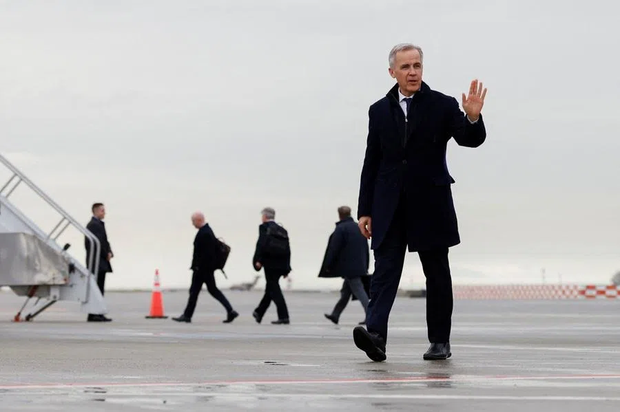 Canada’s Prime Minister Mark Carney walks to board a plane to depart for China, in the first visit by a Canadian prime minister since 2017, at Vancouver International Airport in Richmond, British Columbia, Canada, on 13 January 2026.