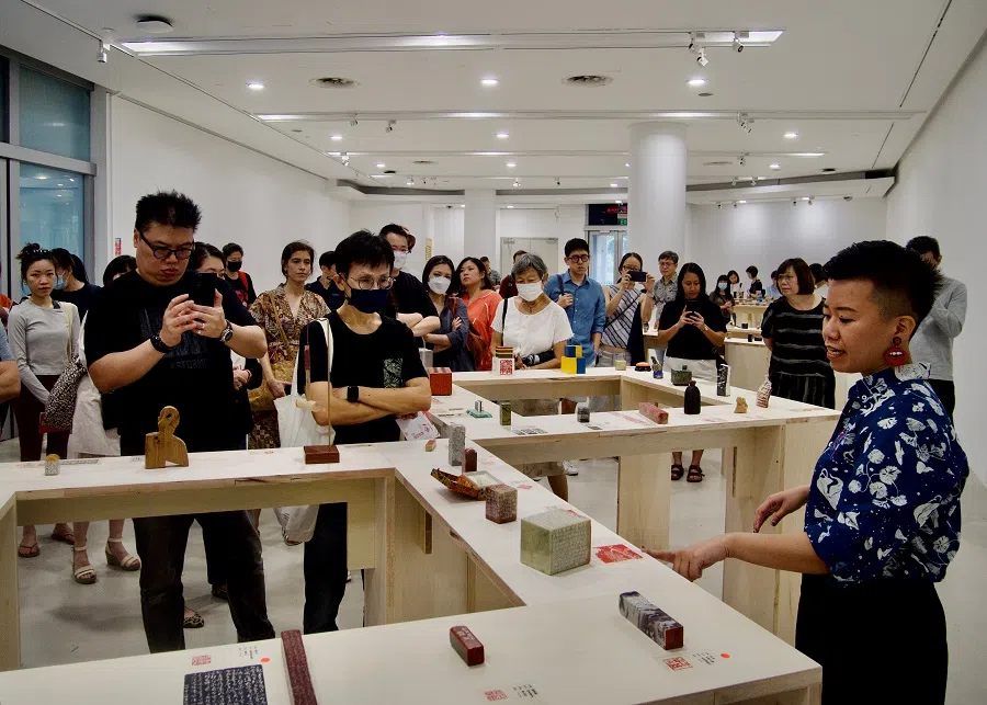Curator Michelle Lim conducts a tour of Carving Possibilities, an exhibition presented by Siaw Tao Chinese Seal Carving, Calligraphy and Painting Society.