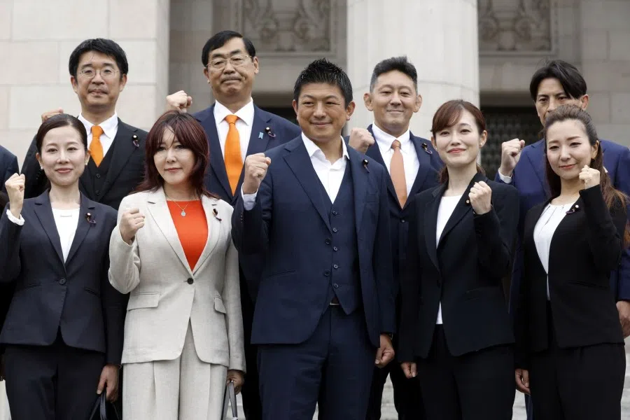 Sohei Kamiya, leader of the Sanseito party (centre), and other parliament members from the party, pose for photographs ahead of an extraordinary session outside the National Diet building in Tokyo, Japan, on 1 August 2025. (Kiyoshi Ota/Bloomberg)