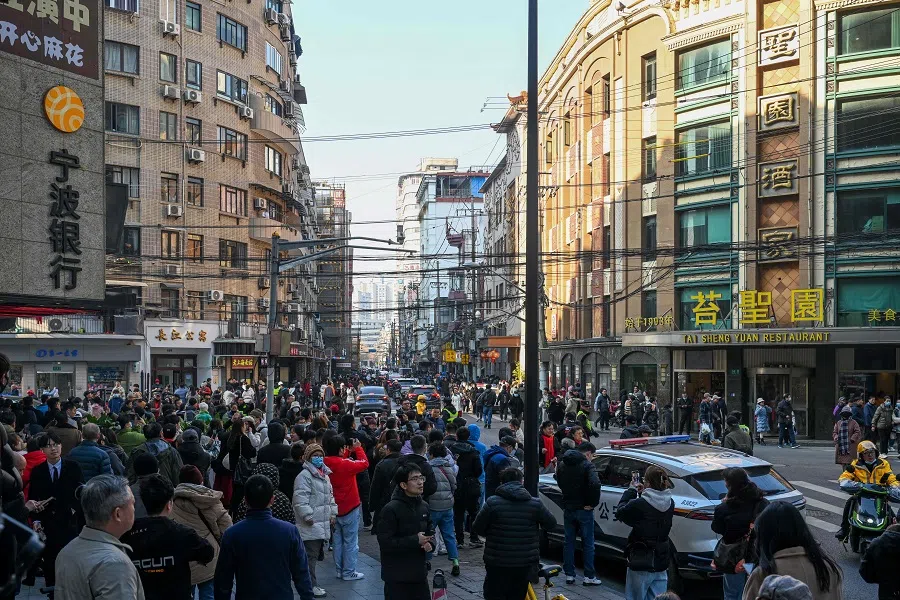 The photo taken on 7 January 2024 shows people visiting Huanghe Road, a historic location that features in the Chinese television series Blossoms Shanghai directed by Hong Kong director Wong Kar-wai, in Shanghai, China. (AFP)