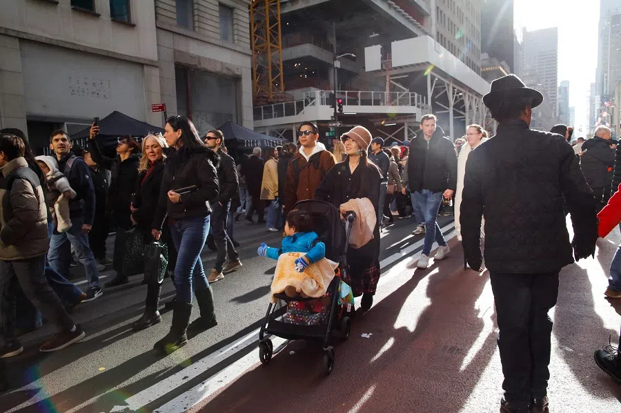 People walk along the 5th avenue in New York on 8 December 2024. (Kena Bentacur/AFP)