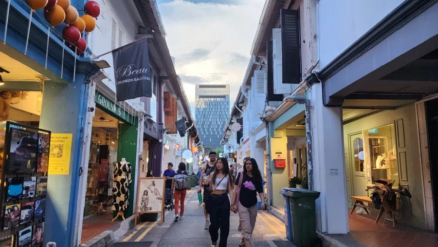 People walk on a small street in Singapore, 9 June 2023. (SPH Media)