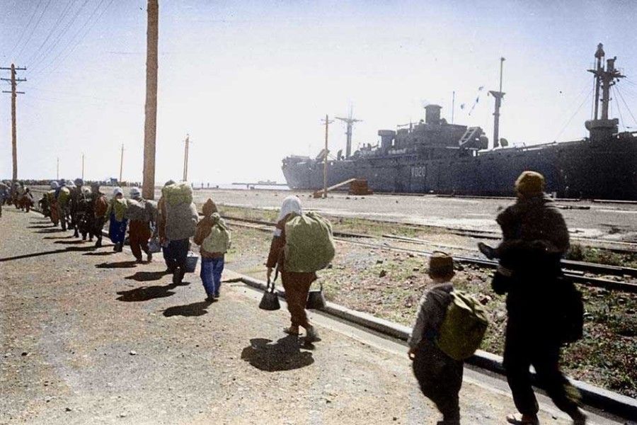 Japanese move towards a US transport vessel at the Port of Huludao to go back to Japan, spring 1945.