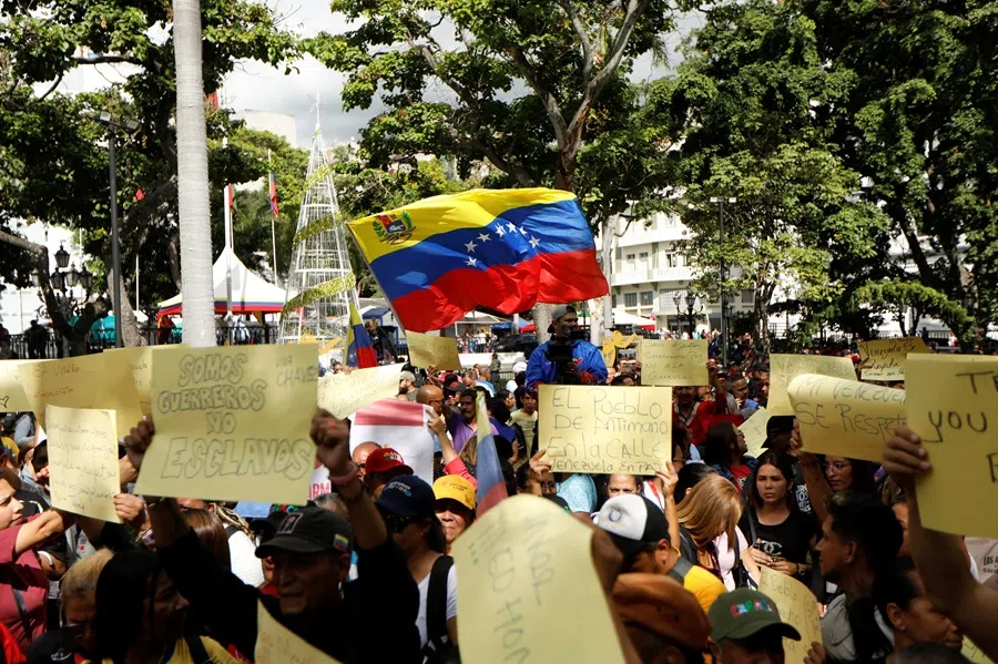 Government supporters participate in a protest against US President Donald Trump’s order to blockade sanctioned oil tankers entering and leaving Venezuela, in Caracas, Venezuela on 17 December 2025. (Leonardo Fernandez Viloria/Reuters)