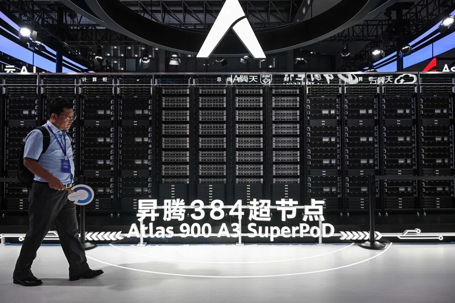 A person walks past a display of an Atlas 900 AI cluster at the Huawei stand during the World Artificial Intelligence Conference (WAIC) at the Shanghai World Expo and Convention Center in Shanghai, China, on 28 July 2025.