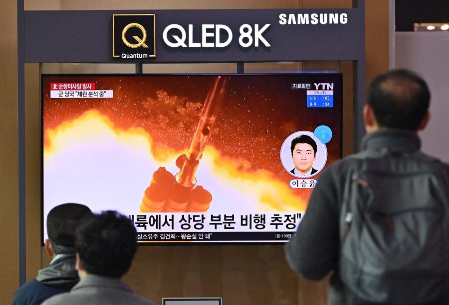 People watch a television screen showing a news broadcast with file footage of a North Korean missile test, at a railway station in Seoul on 25 January 2022, after North Korea fired two suspected cruise missiles according to the South's military. (Jung Yeon-je/AFP)