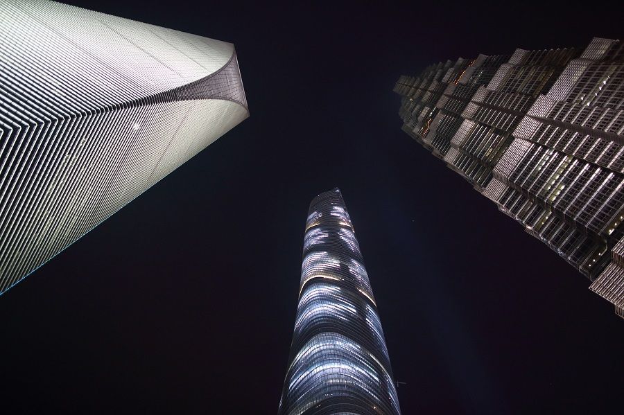 The Shanghai World Financial Center (left), the Shanghai Tower (centre), and the Jin Mao Tower stand illuminated at night in the Lujiazui district of Shanghai, China, 25 April 2015. (Tomohiro Ohsumi/Bloomberg)