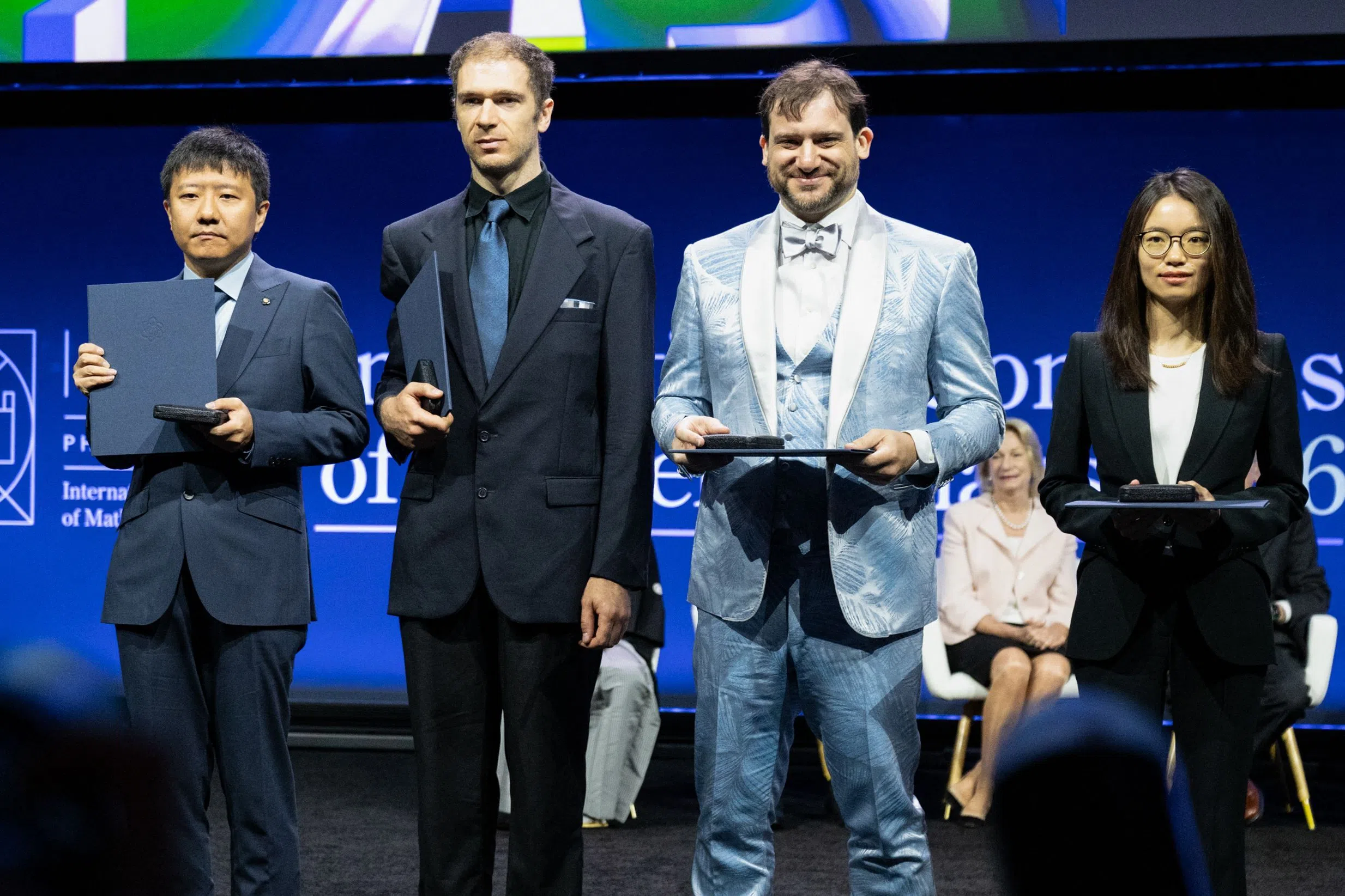 (left to right) 2026 Fields Medalists Chinese mathematician Yu Deng, US mathematician John Pardon, US mathematician Jacob Tsimerman and Chinese mathematician Hong Wang pose for photos onstage after receiving their Fields Medals on 23 July 2026.