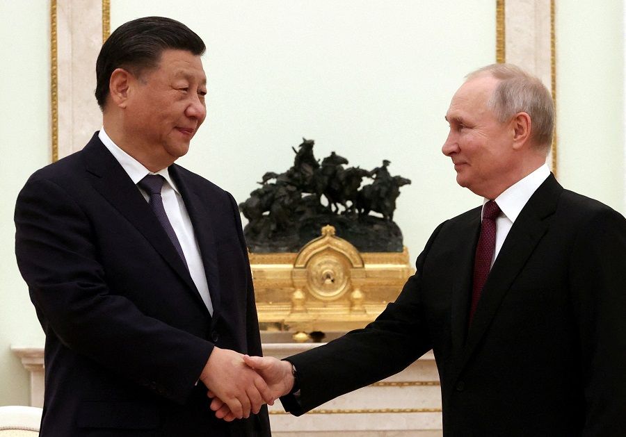Russian President Vladimir Putin shakes hands with Chinese President Xi Jinping during a meeting at the Kremlin in Moscow, Russia, 20 March 2023. (Sputnik/Sergei Karpukhin/Pool via Reuters)