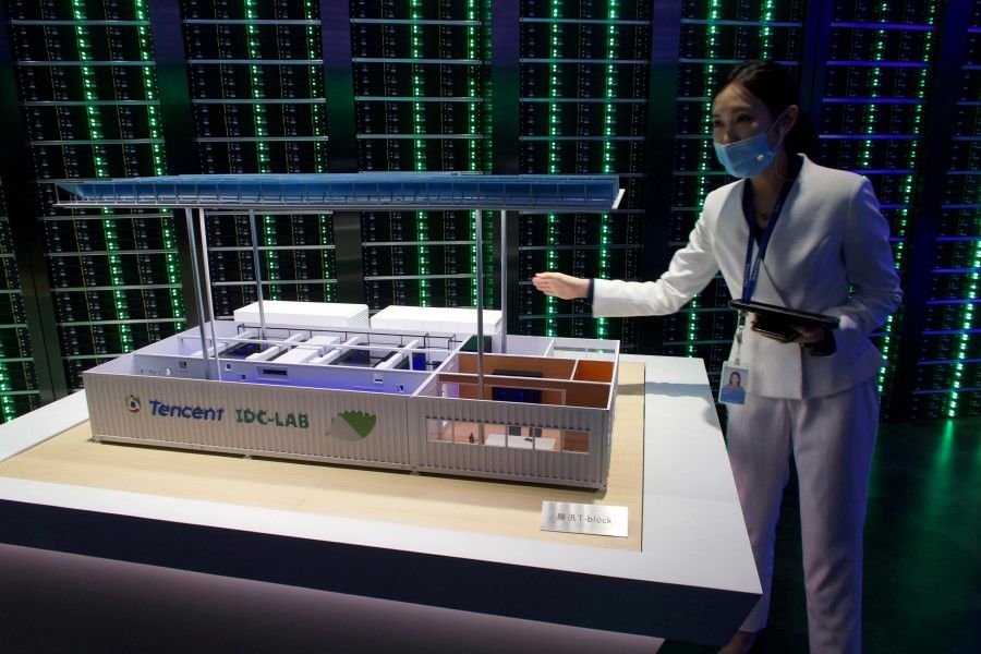 A staff member introduces Tencent's Internet Data Center (IDC) cloud computing service during a government-organised media tour to Tencent headquarters in Shenzhen, Guangdong province, China, 27 September 2020. (David Kirton/REUTERS)