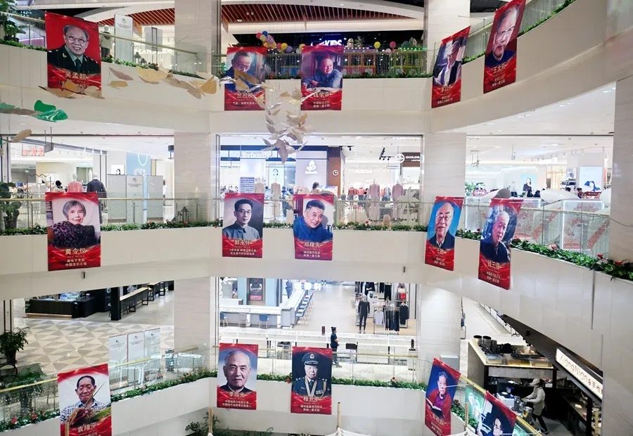 Posters honouring the “Backbones of the Nation” — distinguished figures who have made monumental contributions to the country — were displayed in a prominent location inside a shopping mall in Changchun, Jilin province, showing notable individuals including Qian Xuesen, Deng Jiaxian, Yuan Longping, Tu Youyou, and Wang Daheng, 2 October 2026.