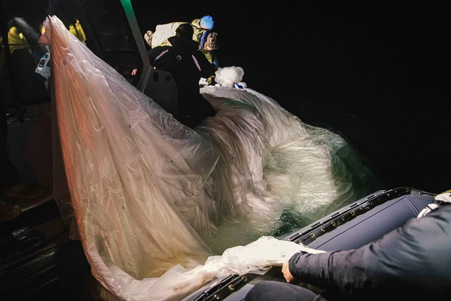 This picture provided by the US Navy shows sailors recovering a Chinese balloon off the coast of Myrtle Beach, South Carolina, in the Atlantic ocean on 5 February 2023. (Petty Officer 1st Class Tyler Thompson/US Navy/AFP)