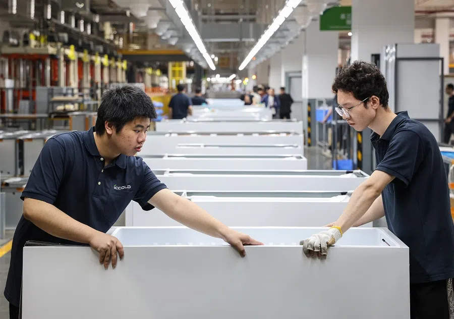 Workers at a production facility in Guangzhou, on 22 March 2025.