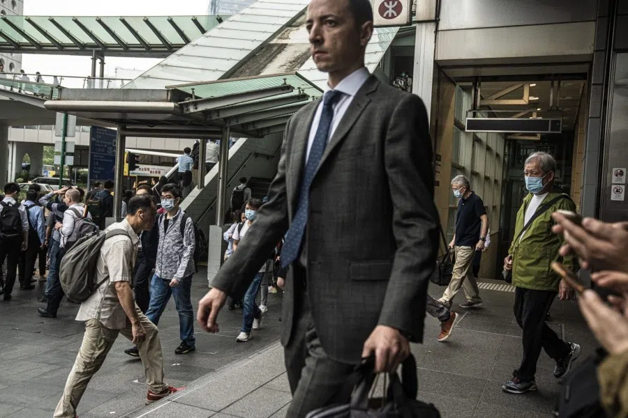 Pedestrians exit a MTR station in Hong Kong, China, on 24 April 2023. (Lam Yik/Bloomberg)