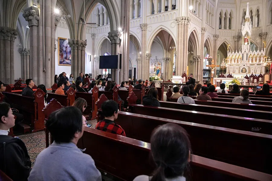 People pray at the Saint Ignatius Cathedral at the Xuhui district in Shanghai on 22 April 2025. (Hector Retamal/AFP)