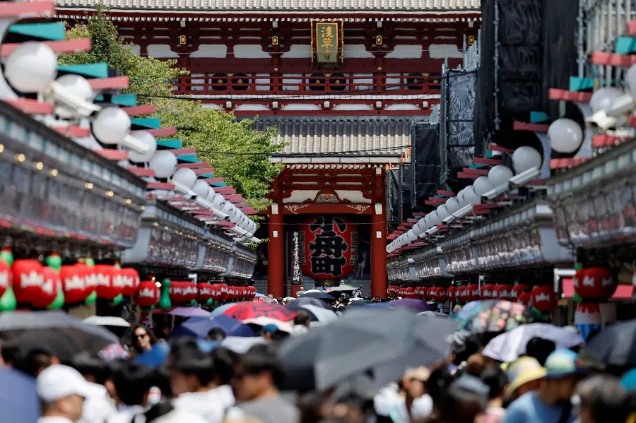 Visitors walk along Nakamise-dori Street as they visit Sensoji temple in Tokyo, Japan, 9 August 2024. (Willy Kurniawan/Reuters)