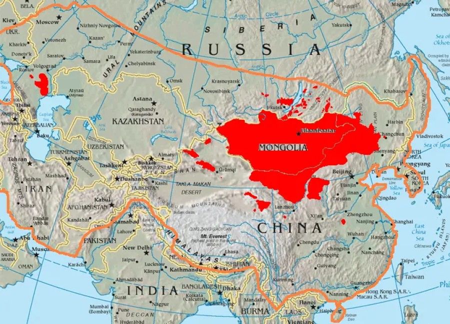 The orange line shows the extent of the Mongol empire in the late 13th century. The red areas are the places dominated by ethnic Mongols today. (Wikimedia)