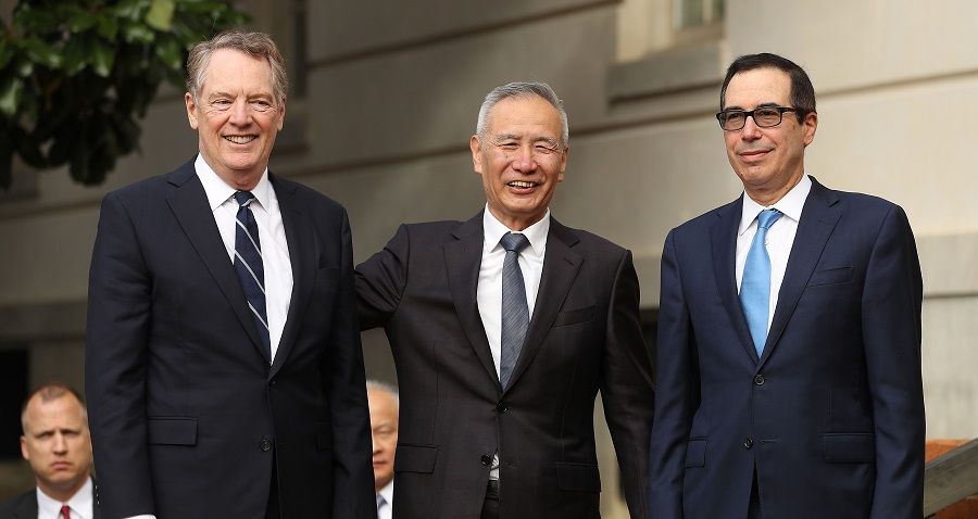 Chinese Vice Premier Liu He (C) poses for photographs with U.S. Trade Representative Robert Lighthizer (L) and Treasury Secretary Steven Mnuchin at trade negotiations in Washington in October 2019 (Chip Somodevilla/Getty Images/AFP)
