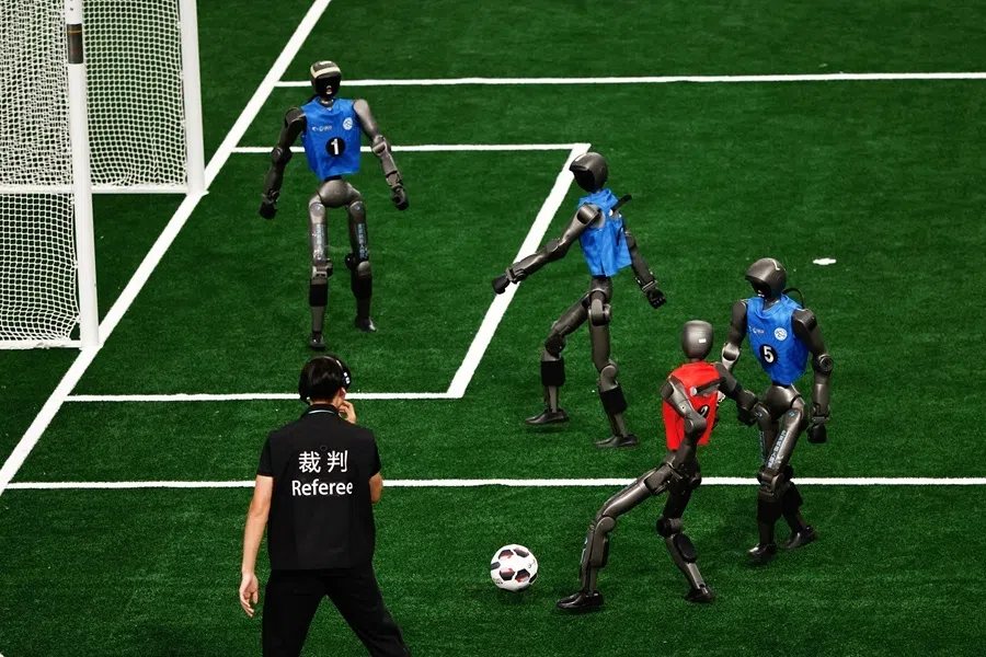 T2 humanoid robots by Booster Robotics take part in a quarterfinal of 5v5 large size group football match, during 2026 World Humanoid Robot Games, at the National Speed Skating Oval, in Beijing, China, on 23 August 2026.