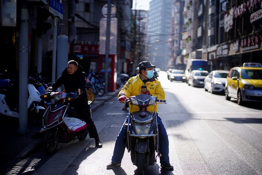 A Meituan delivery worker wearing a mask is seen on a street in Shanghai, China, 13 January 2021. (Aly Song/File Photo/Reuters)