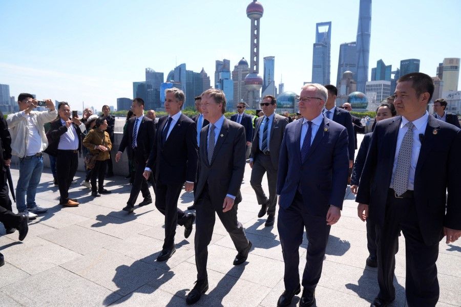 US Secretary of State Antony Blinken, US ambassador to China Nicholas Burns, and Scott Walker, consul-general at the US consulate-general walk in a waterfront area called The Bund, in Shanghai, China, on 25 April 2024.  (Mark Schiefelbein/Reuters)
