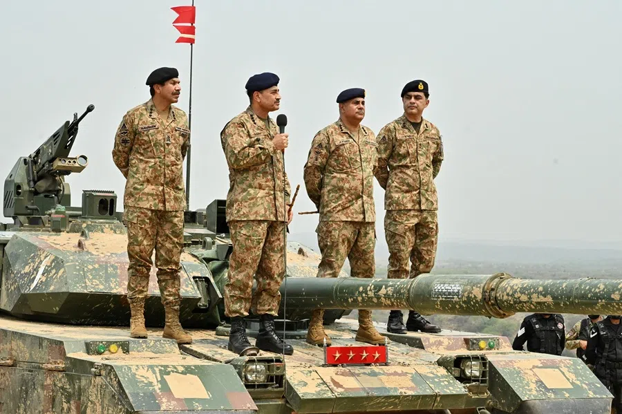 Chief of Army Staff of Pakistan Asim Munir holds a microphone during his visit at the Tilla Field Firing Ranges to witness the Exercise Hammer Strike, a high-intensity field training exercise conducted by the Pakistan Army's Mangla Strike Corps, in Mangla, Pakistan, 1 May 2025. (Inter-Services Public Relations/Handout via Reuters)