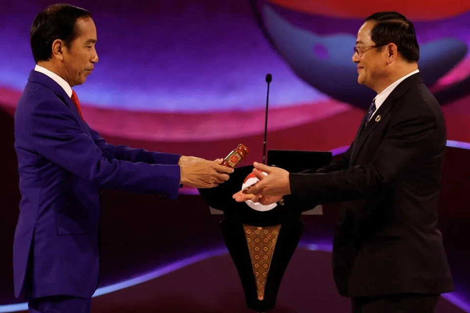 Indonesian President Joko Widodo passes ASEAN's hammer to Laotian Prime Minister Sonexay Siphandone, during the closing ceremony of the 43rd ASEAN Summit in Jakarta, Indonesia, on 7 September 2023. (Willy Kurniawan/Reuters)